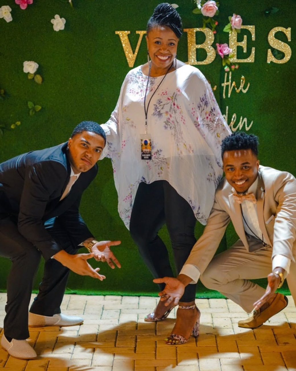 Brandon with his mom and twin brother at a garden event