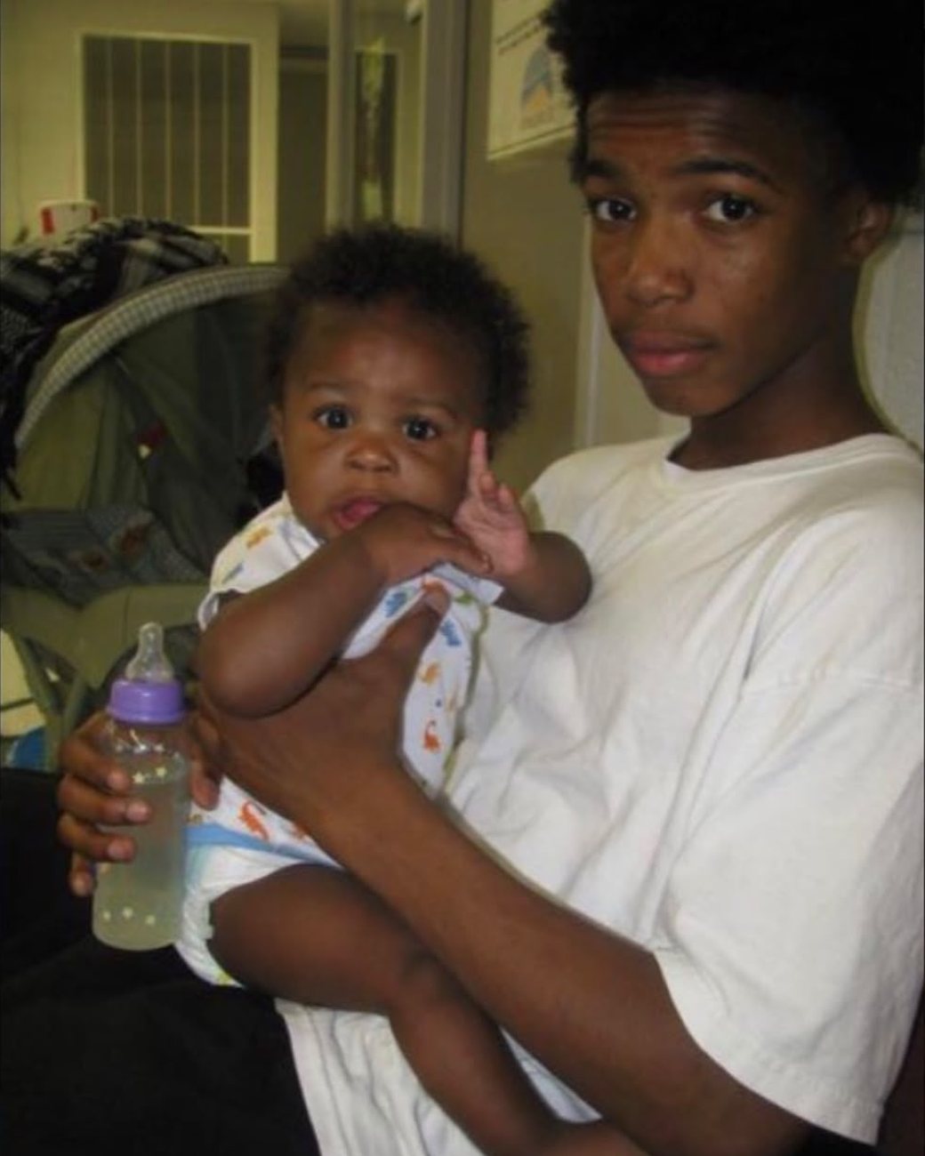 A young Brandon holding his baby
