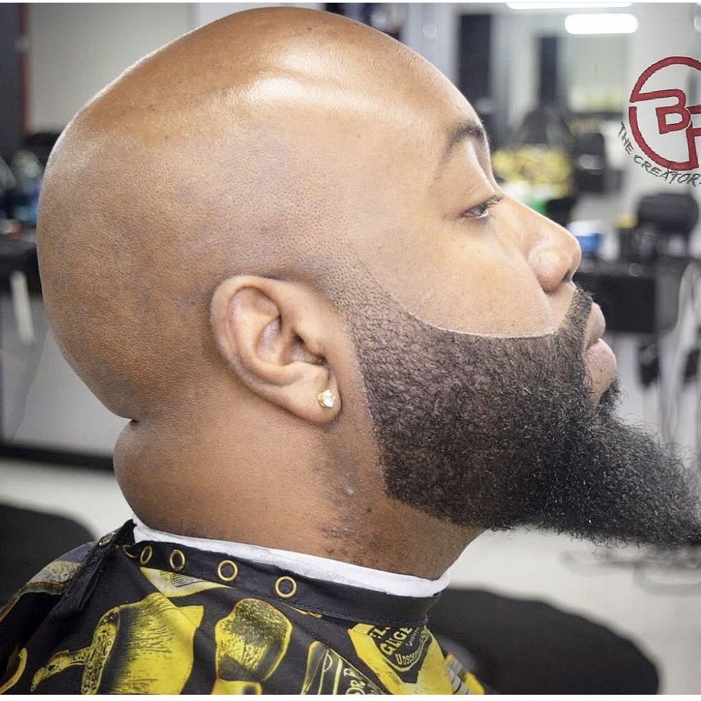 Clean bald shave with sculpted full beard