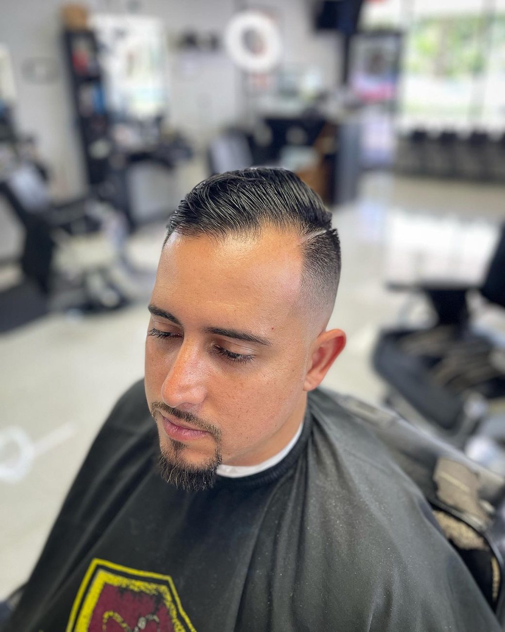 Comb-over with a skin fade and goatee