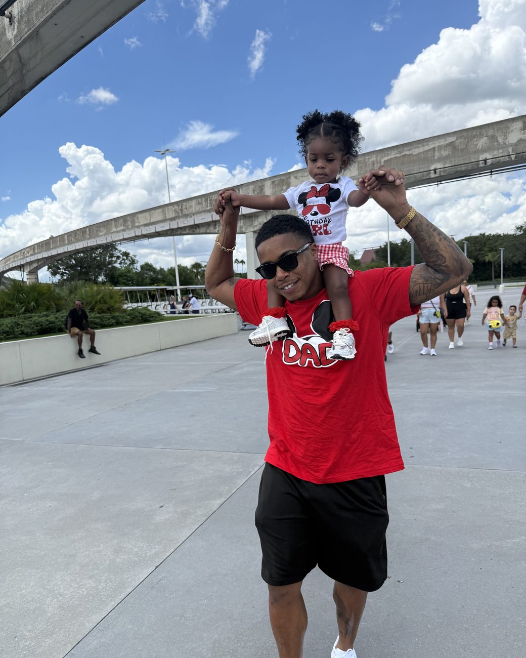 Brandon carrying his daughter on his shoulders at Disney