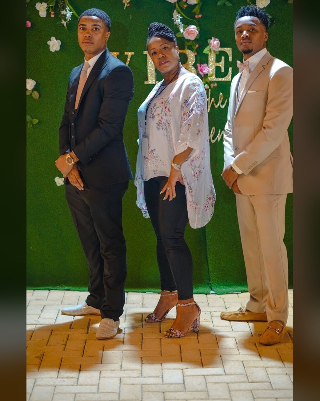 Brandon with family at a garden-themed celebration
