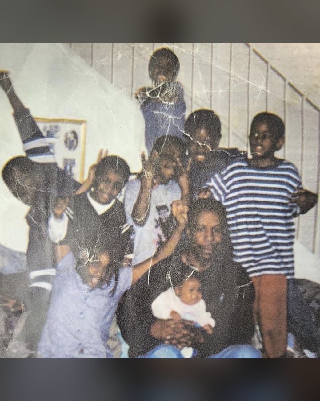 Vintage family photo full of kids gathered around their grandfather