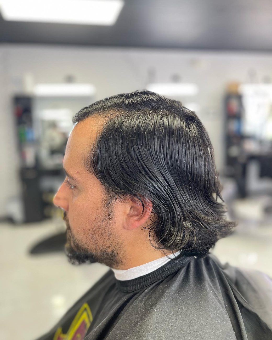 Slicked-back flow with a beard trim