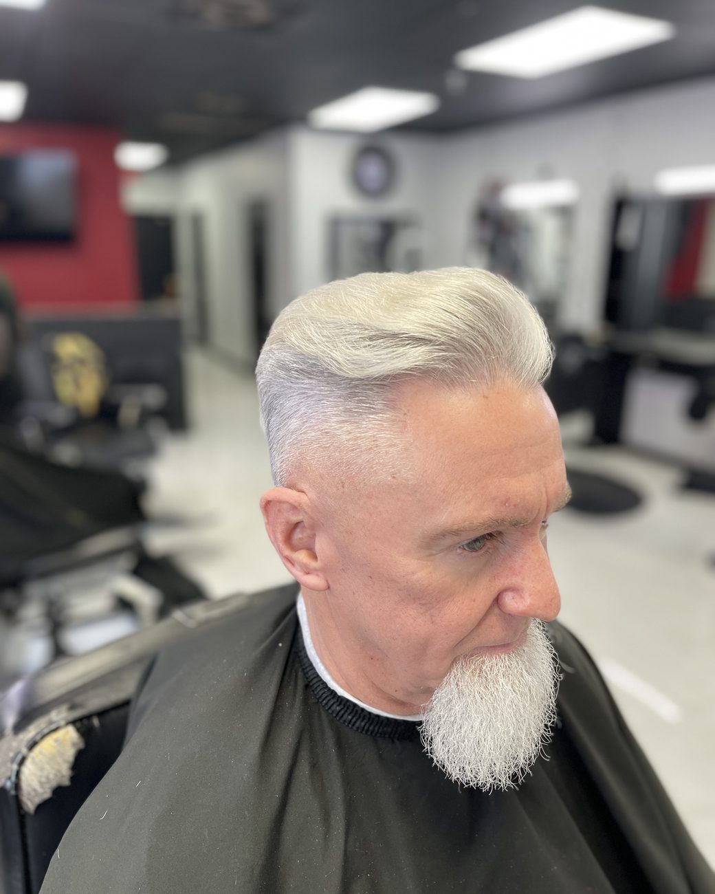 Silver pompadour with a sculpted white beard