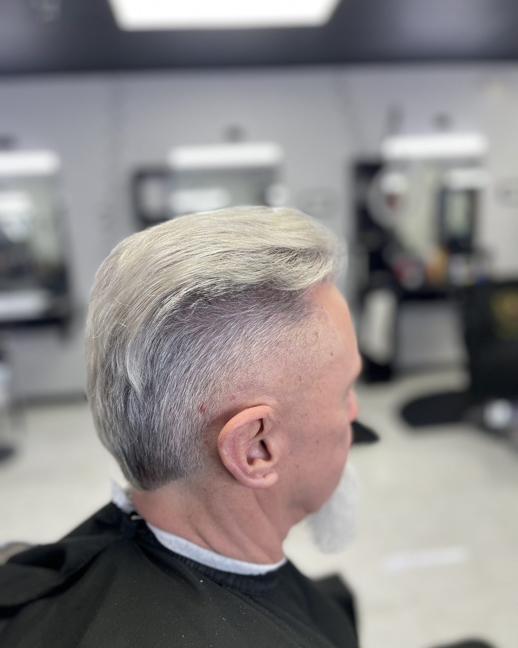 Silver pompadour with a taper, side view