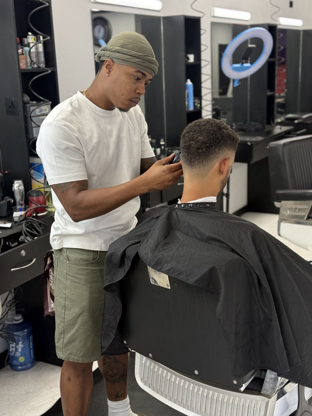 Brandon working on the back of a client's fade