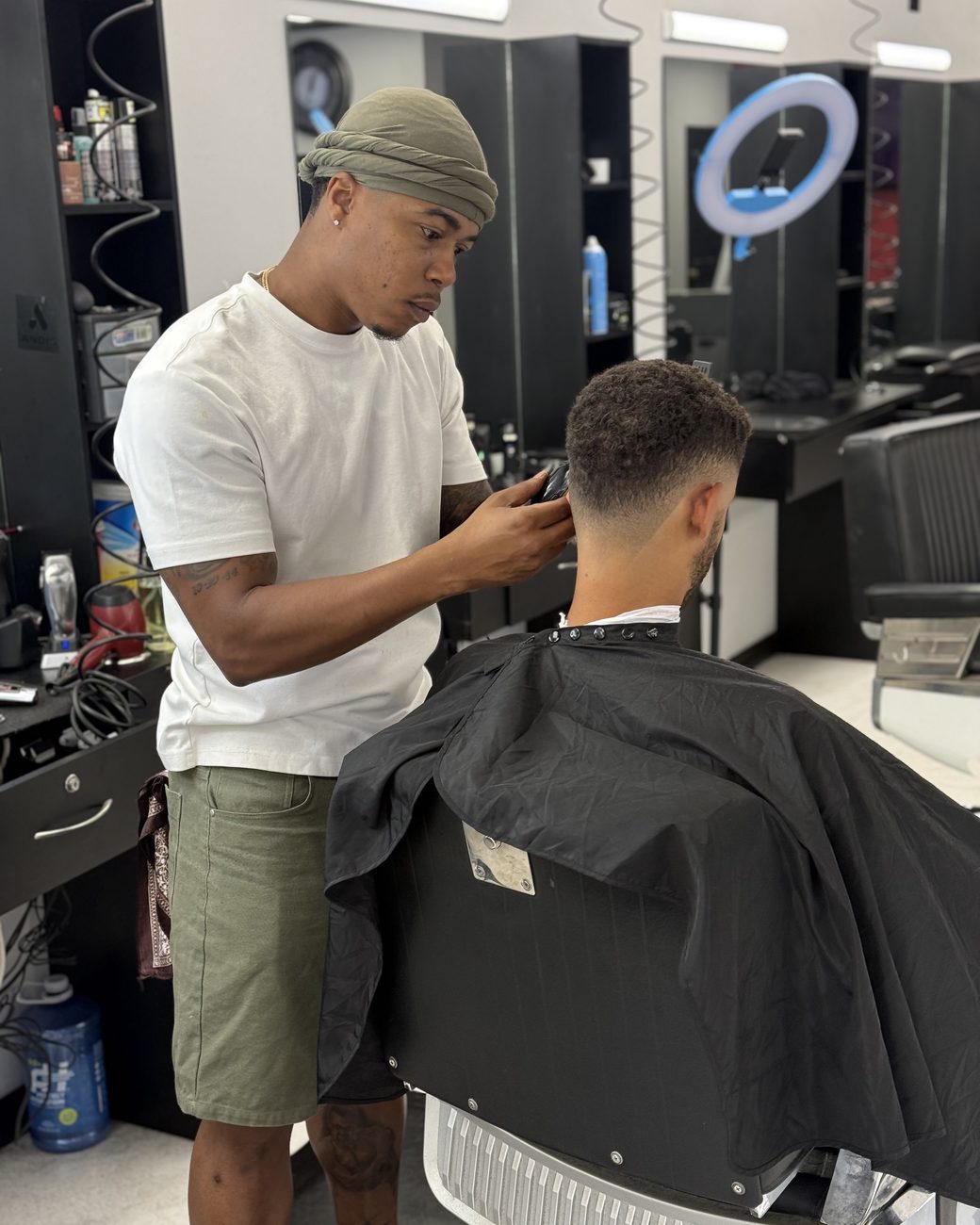 Brandon working the clippers around a client's fade