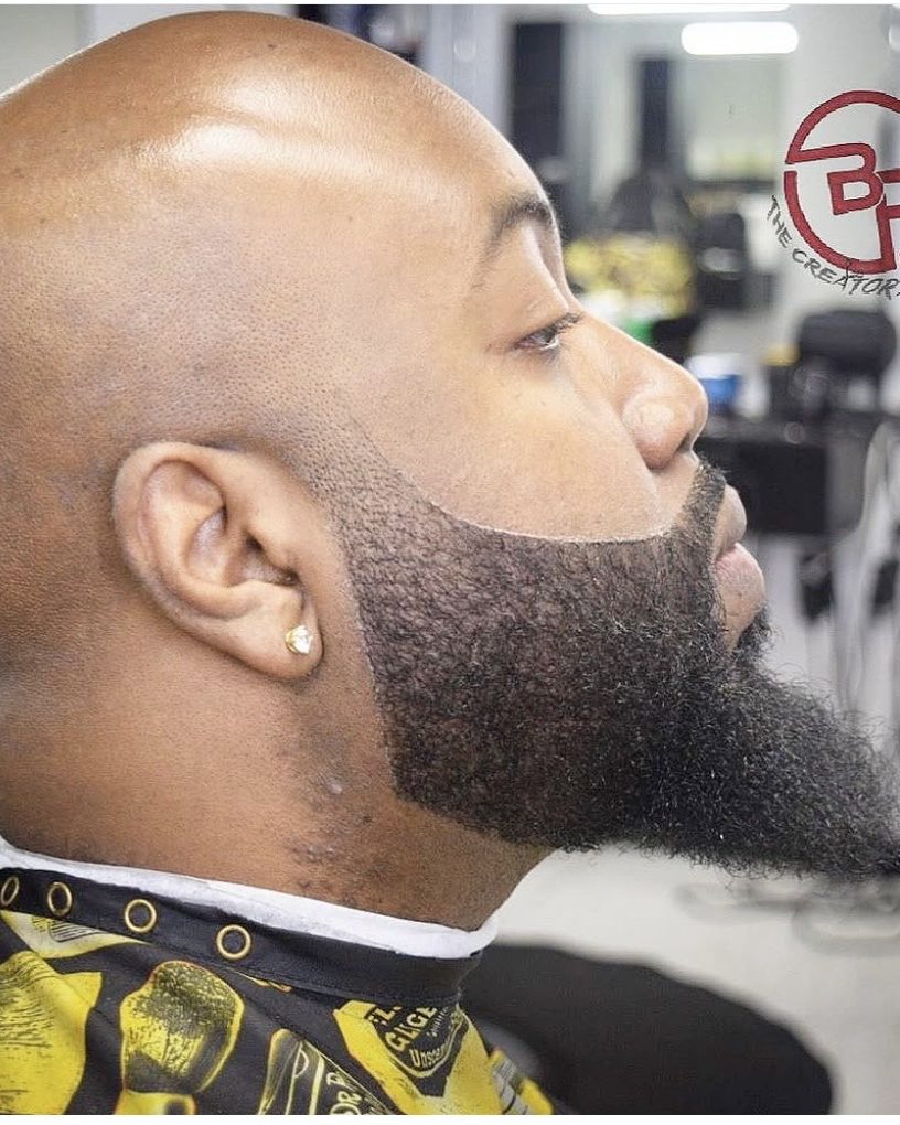 Clean bald shave with a sculpted full beard