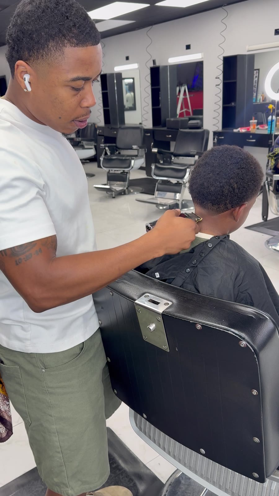 Brandon cleaning up the neckline on a young client
